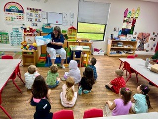 Leda reads a story to her classroom of preschoolers.