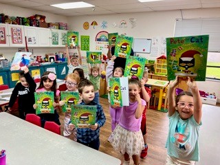 Preschool children are excited about receiving their new books!