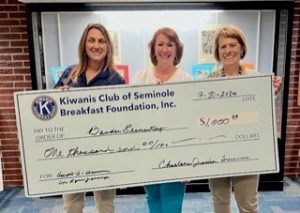 Check presented to school counselor Lynn Jennings (L) and Principal Cecelia Palmer (R) at Bauder Elementary.