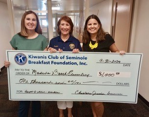 Check presented to Asst Principal Brooke Crandall (L) and school counselor Malinda Motte (R) at Madeira Beach Fundamental Elementary.