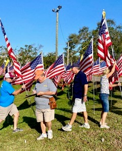 Volunteers raise the flags!