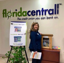 Branch Manager Tanja Jumrukovska with new library box at Floridacentral Credit Union, Seminole.