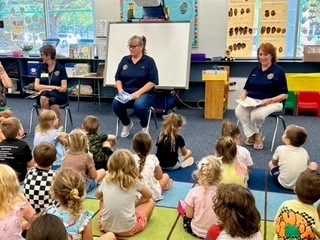 Linda, Leda & Charlene reading to preschoolers.