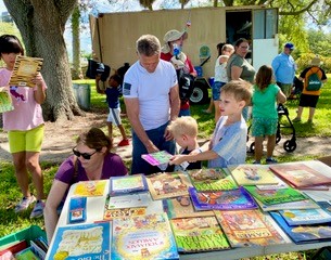 Children choose free books at our Family Fishing Day event.