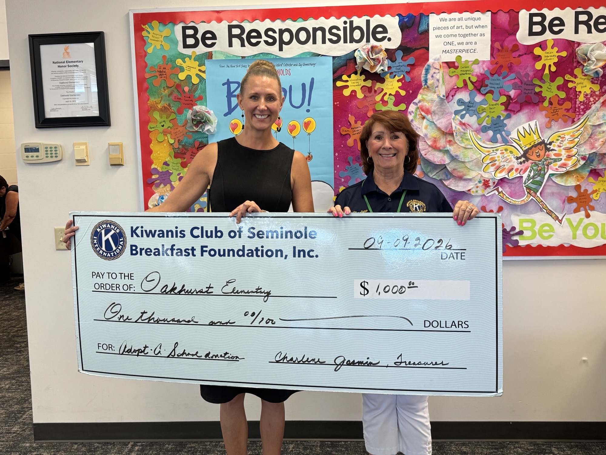Treasurer Charlene presents a check to Oakhurst Elementary School Principal Jolene Jackson.