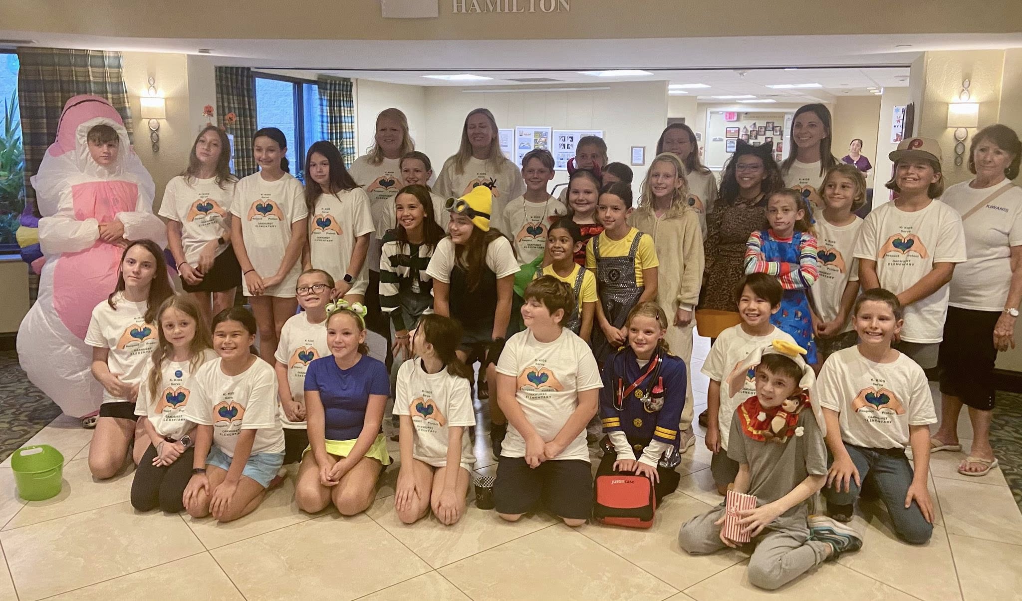 Oakhurst K-Kids pose for a group photo following their 2025 Reverse Trick-or-Treat visit to Freedom Square.