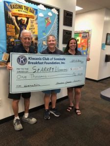 Dale and Leah presenting a check to Starkey Elementary School Principal Laura Kranzel.